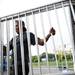 A carnival employee carries a piece of fencing out of a truck at Pioneer High School on Tuesday, June 25. Daniel Brenner I AnnArbor.com